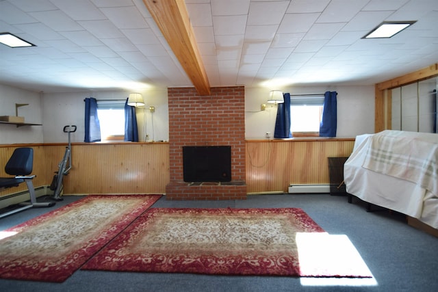 interior space with a wealth of natural light, a wainscoted wall, a fireplace, and carpet flooring