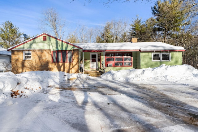 view of front facade featuring a garage and a chimney