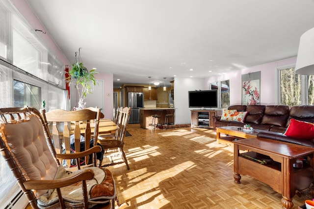 living room with beverage cooler and a baseboard heating unit