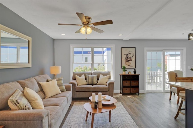 living area with light wood-type flooring, ceiling fan, baseboards, and recessed lighting