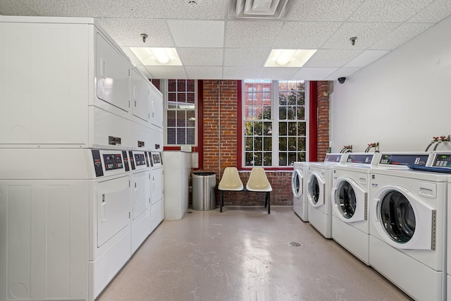 shared laundry area with separate washer and dryer and stacked washing maching and dryer