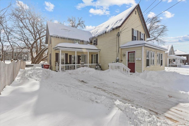 exterior space with covered porch and fence