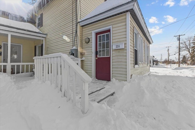 view of snow covered property entrance