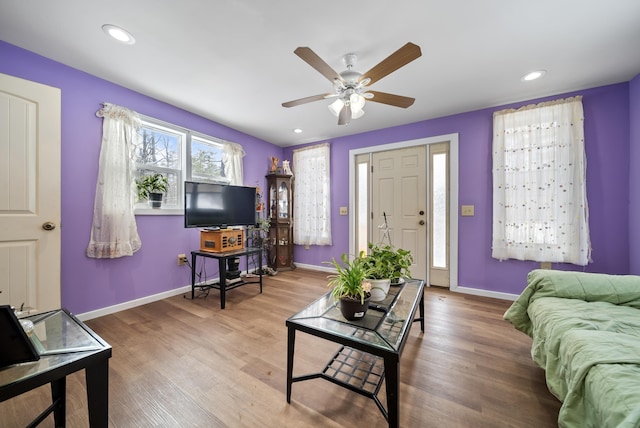 living area featuring recessed lighting, baseboards, and wood finished floors