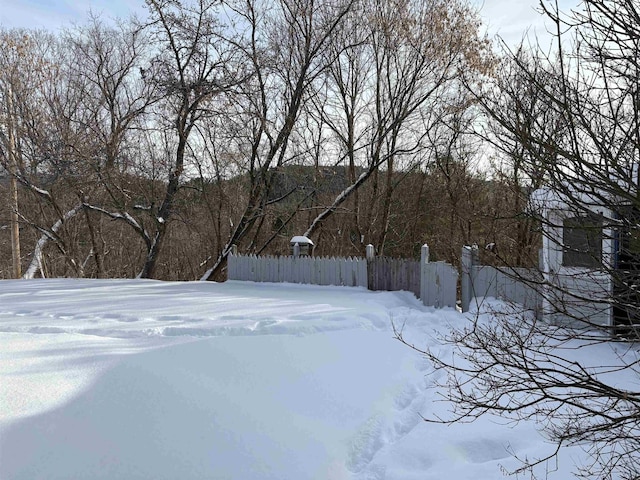 yard layered in snow with fence