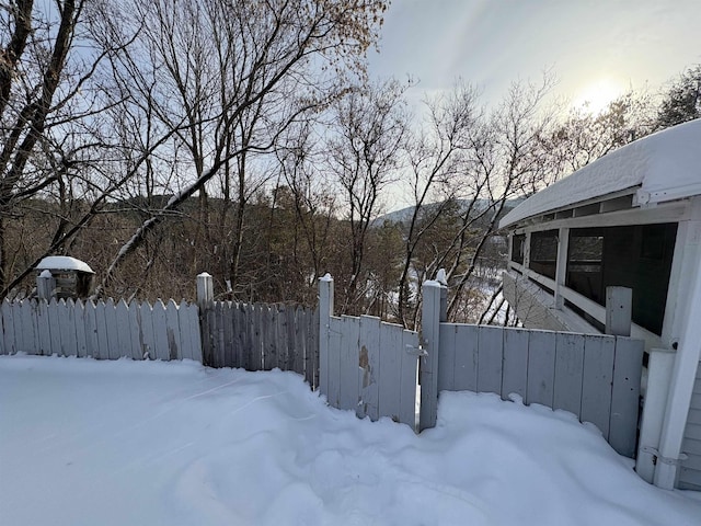 snowy yard with fence