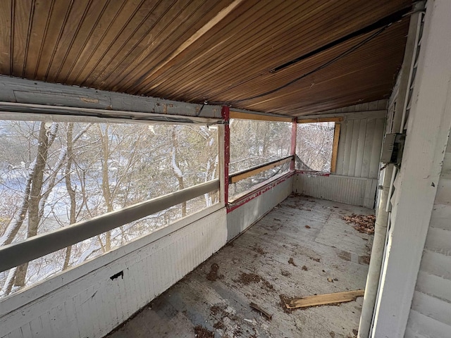 unfurnished sunroom with wood ceiling