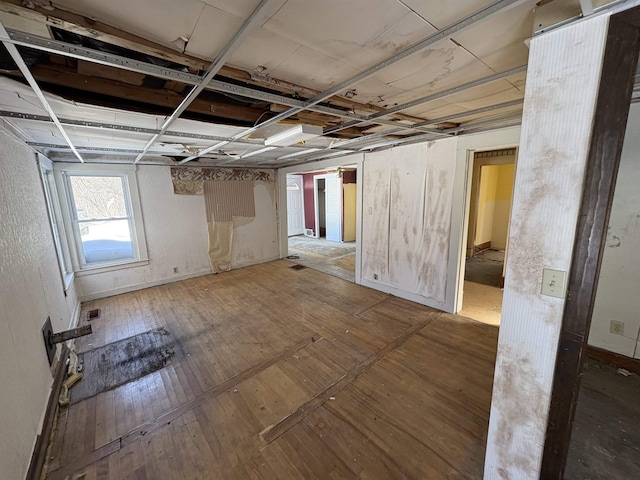 basement with visible vents and wood finished floors