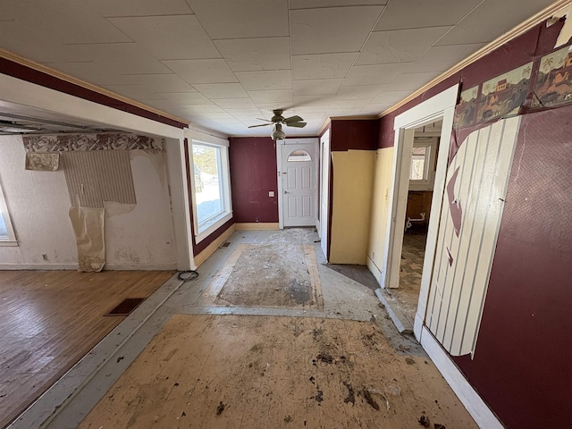 foyer entrance featuring ceiling fan and baseboards