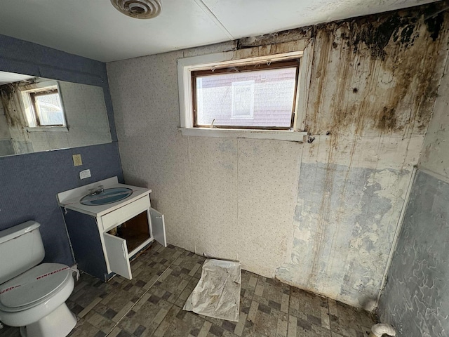 bathroom featuring toilet, visible vents, and vanity