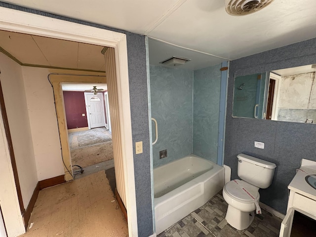 bathroom featuring toilet, vanity, wood finished floors,  shower combination, and baseboards