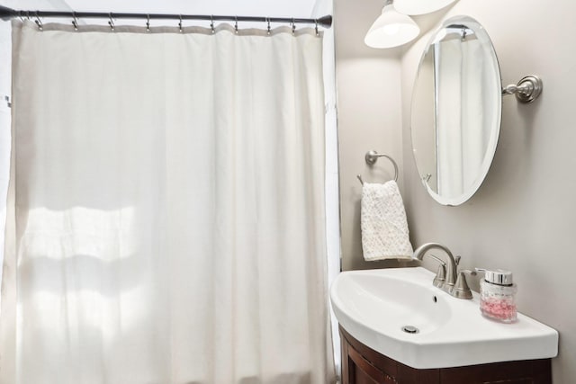 full bathroom with a shower with shower curtain and vanity