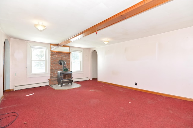 unfurnished living room featuring arched walkways, baseboards, a baseboard radiator, a wood stove, and carpet floors