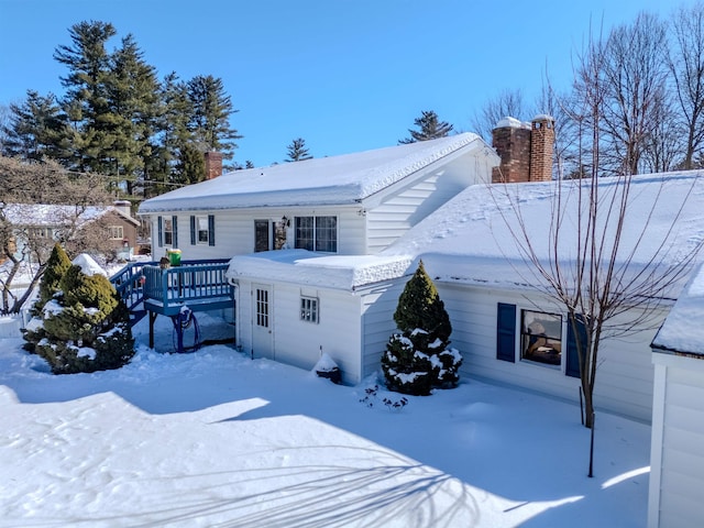 exterior space with a deck and a chimney