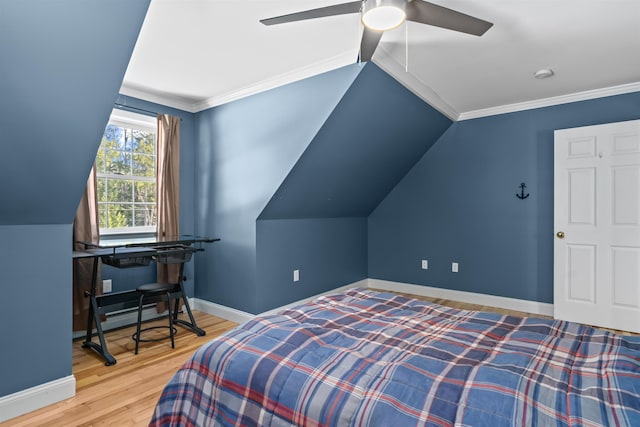 bedroom featuring crown molding, lofted ceiling, ceiling fan, wood finished floors, and baseboards