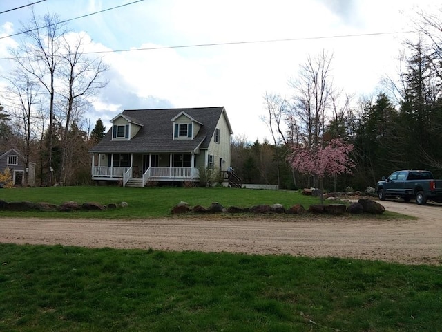 view of front of property with covered porch and a front yard