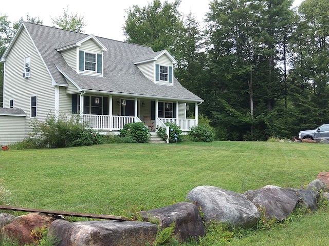 cape cod house featuring a porch, roof with shingles, and a front yard