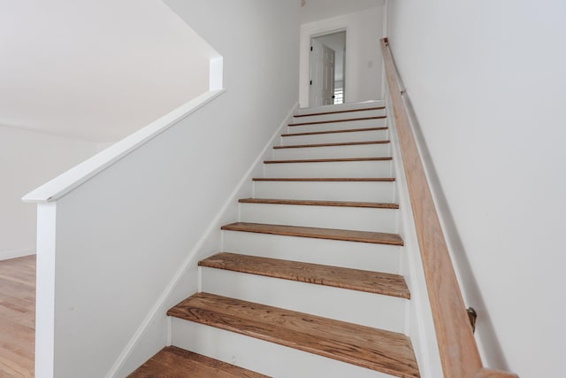 stairs featuring baseboards and wood finished floors