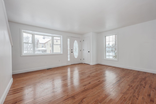 interior space featuring light wood finished floors and baseboards