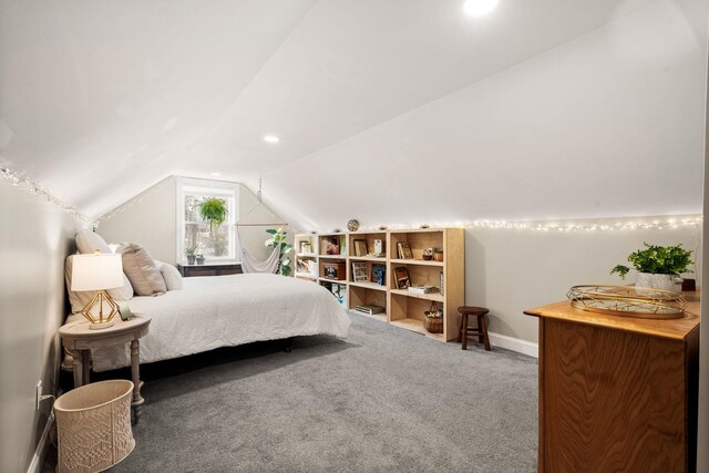 bedroom with vaulted ceiling, carpet floors, and baseboards