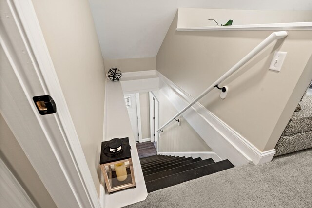 stairway with carpet floors and baseboards