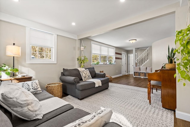 living area with recessed lighting, wood finished floors, baseboards, stairway, and beamed ceiling