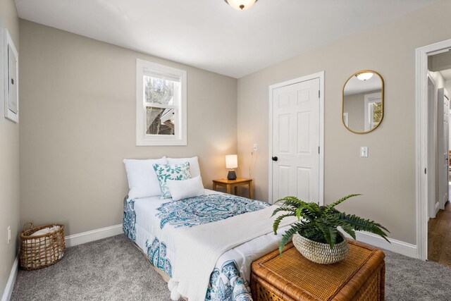 carpeted bedroom featuring baseboards