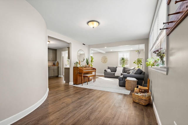 entrance foyer with dark wood-style flooring and baseboards