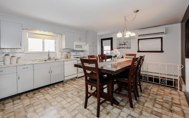 dining space featuring a baseboard heating unit, an inviting chandelier, and a wall mounted AC