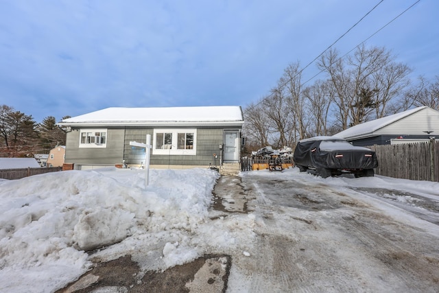 view of front of house with a garage and fence