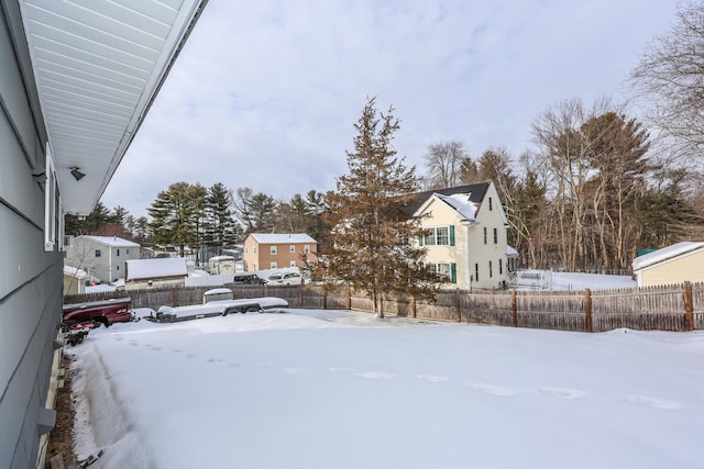 snowy yard with fence