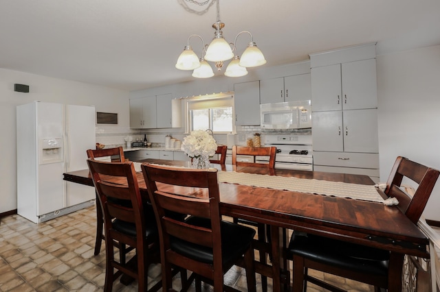 dining space with an inviting chandelier