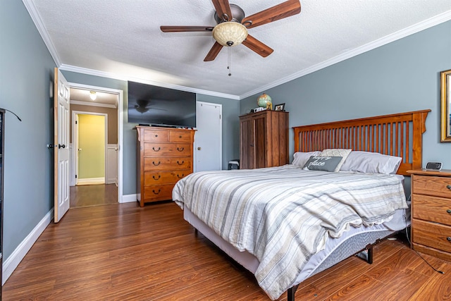 bedroom with dark wood-style floors, baseboards, ornamental molding, and a textured ceiling