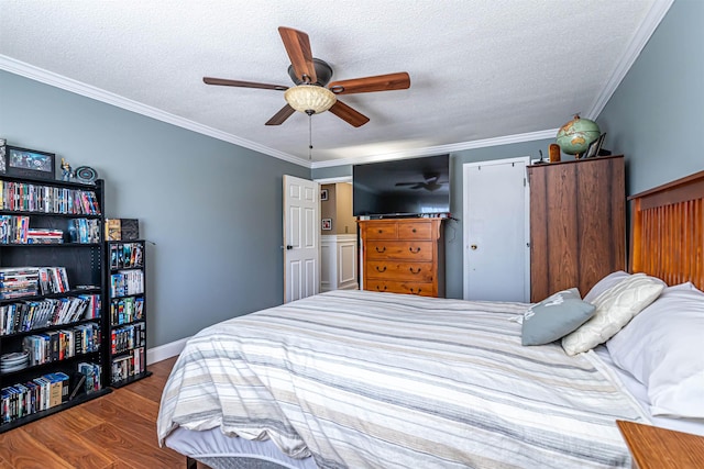 bedroom featuring crown molding, a textured ceiling, and wood finished floors