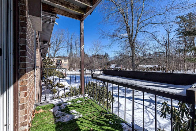 view of snow covered back of property