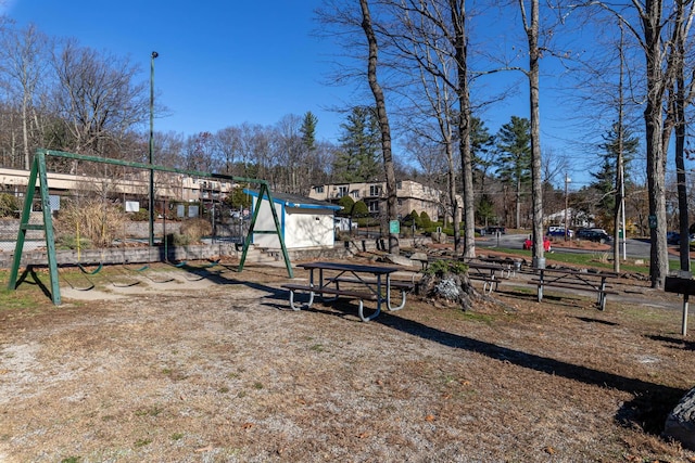 view of jungle gym with a storage shed