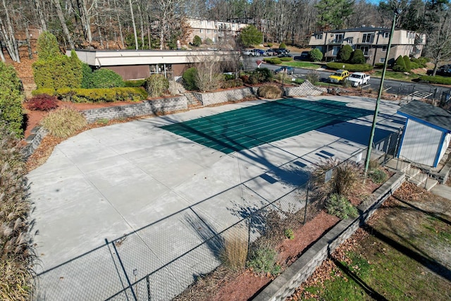 view of swimming pool featuring fence