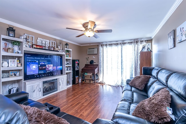 living area with a ceiling fan, an AC wall unit, crown molding, and wood finished floors