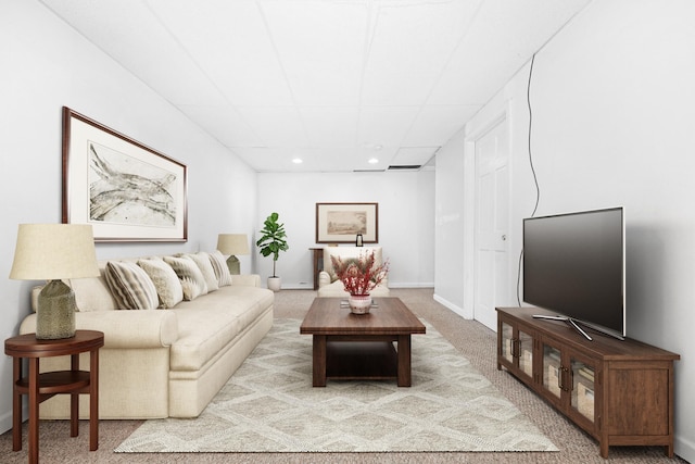 living area featuring carpet floors, baseboards, a paneled ceiling, and recessed lighting