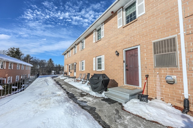 exterior space with brick siding