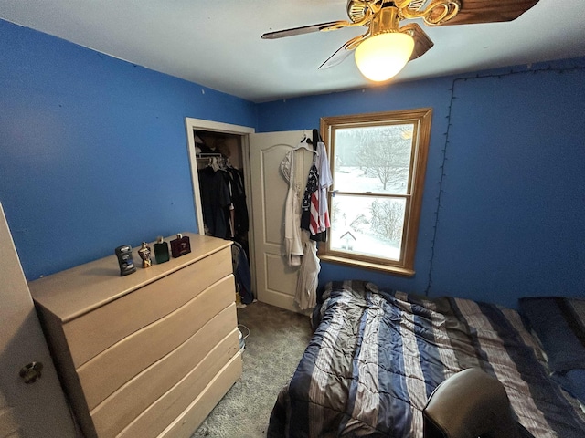 unfurnished bedroom with ceiling fan and dark carpet