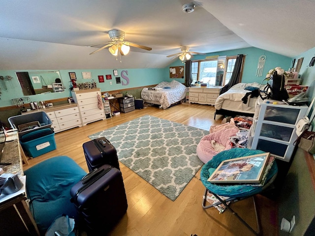 bedroom featuring ceiling fan, vaulted ceiling, and wood finished floors