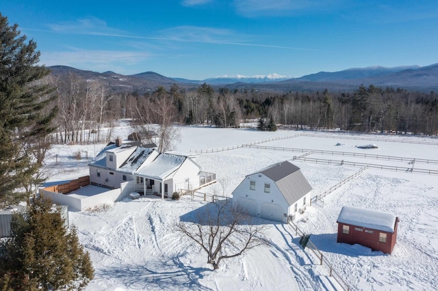 snowy aerial view featuring a mountain view