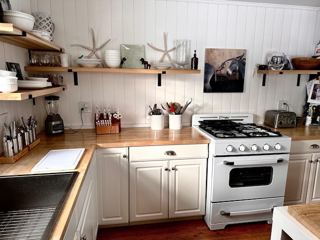 kitchen with a toaster, a sink, white cabinetry, white range with gas cooktop, and open shelves