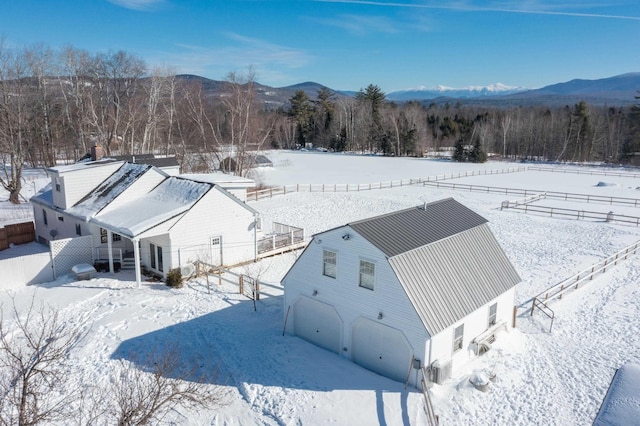 snowy aerial view with a mountain view