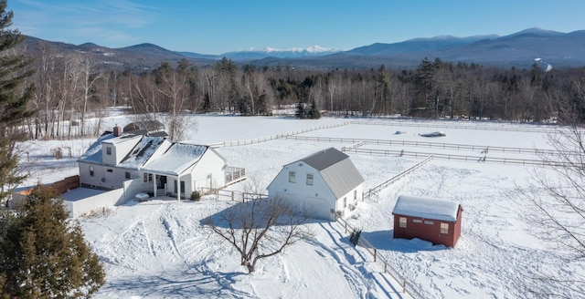 snowy aerial view with a mountain view