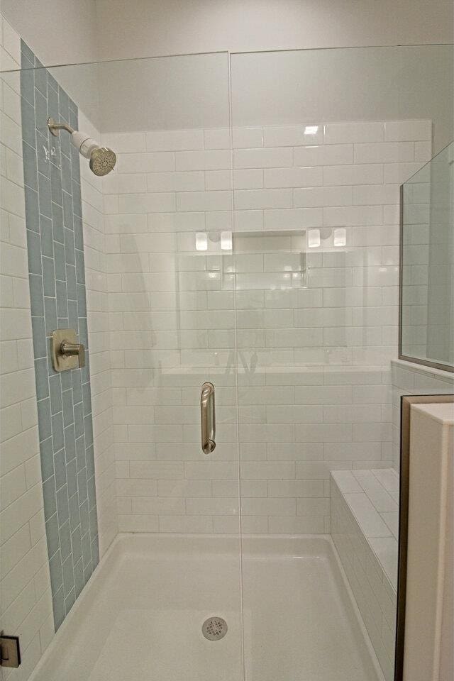 bathroom featuring a shower stall