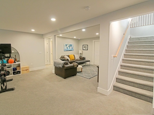 living area with recessed lighting, light colored carpet, stairway, and baseboards