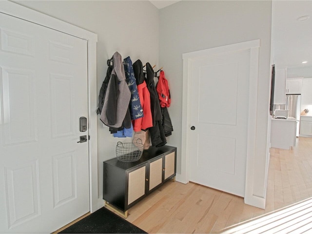 mudroom with light wood finished floors