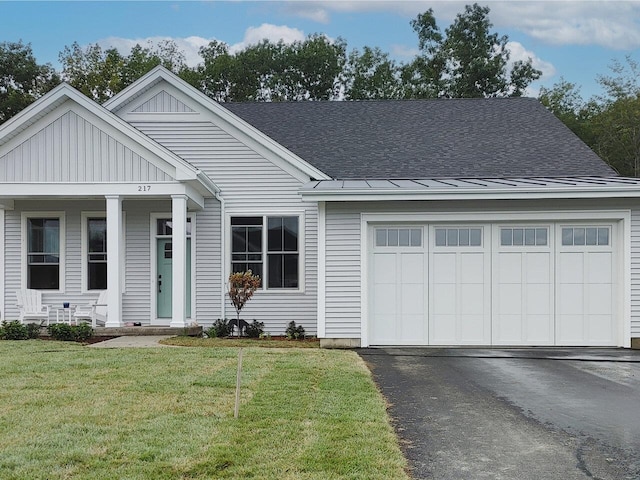 view of front of property featuring aphalt driveway, a shingled roof, board and batten siding, a garage, and a front lawn